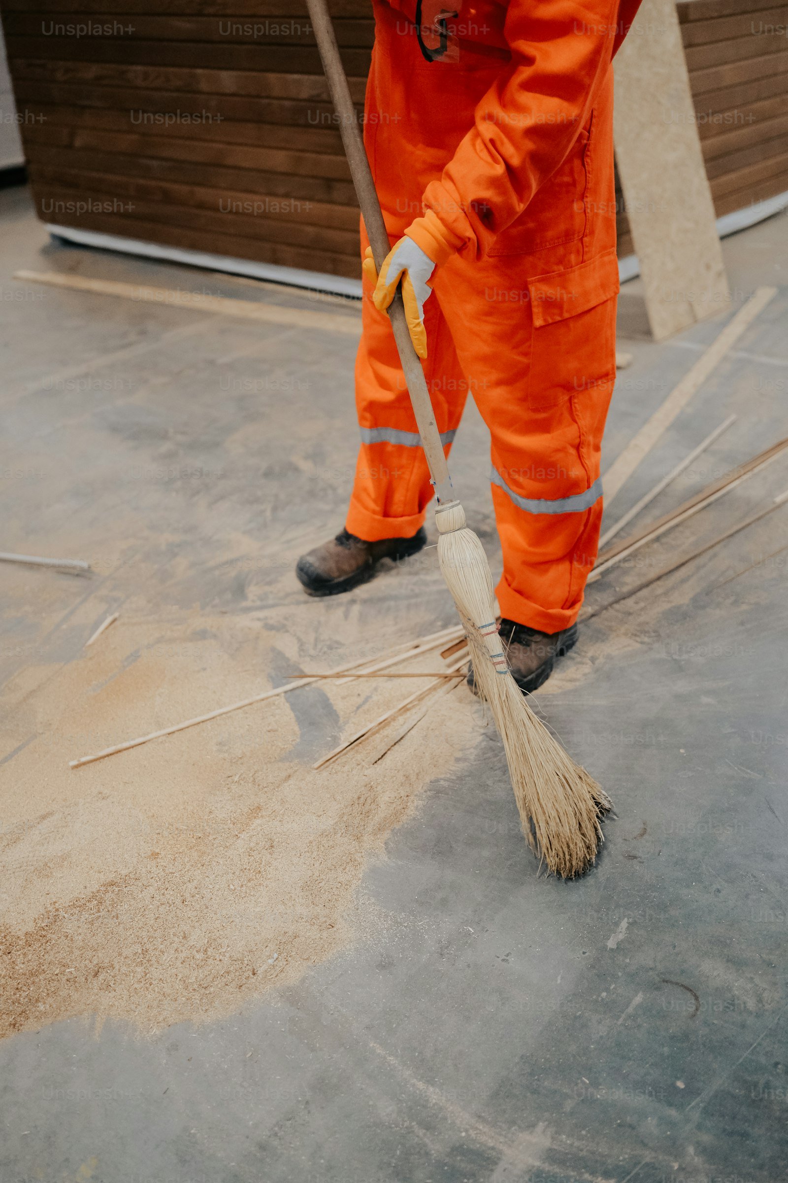 Worker sweeping newly finished interior floor