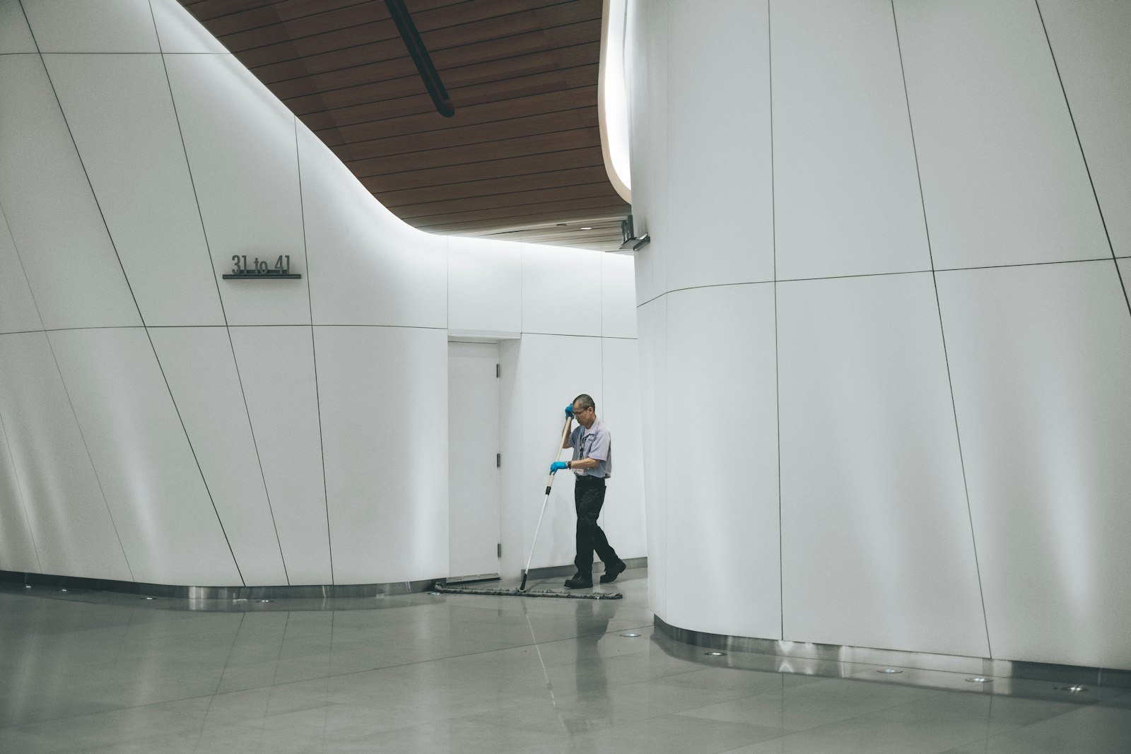 Worker cleaning indoor floor area